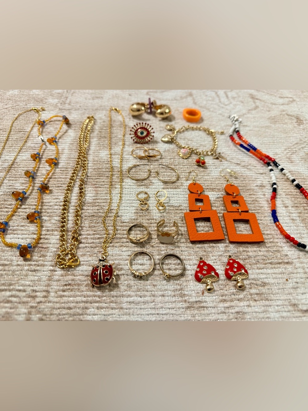 Gold-Tone Jewelry Set with Orange Statement Earrings and Red Ladybug Pendant